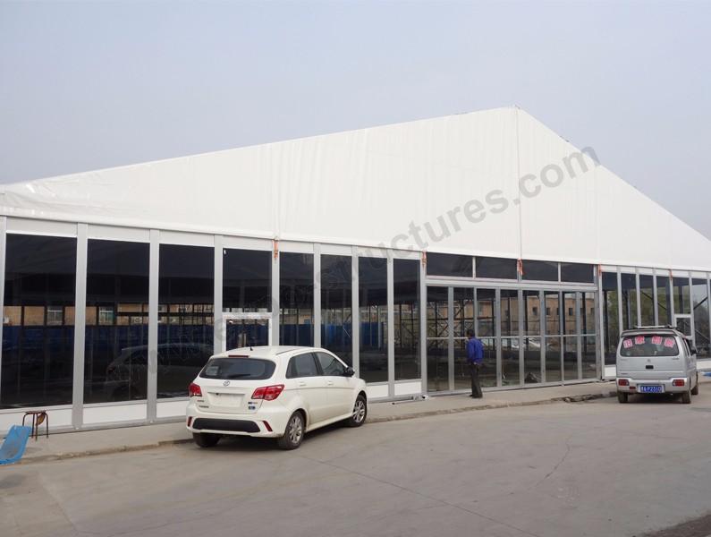Outdoor marquee tent with glass panel wall